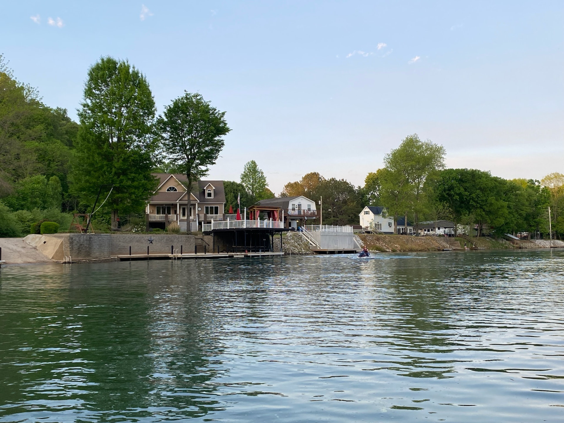 Waterfront view of both lake houses, the covered dock pavilion and the shoreline